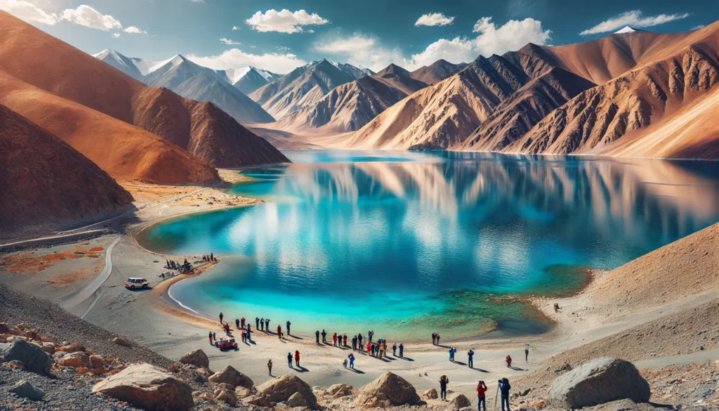 stunning view of Pangong Lake in Ladakh, surrounded by majestic mountains with crystal-clear blue water under a clear sky.